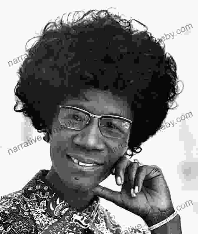 A Black And White Photograph Of Shirley Chisholm, Smiling And Looking Directly At The Camera. She Is Wearing A Dark Dress And A Pearl Necklace. Shirley Chisholm Is A Verb