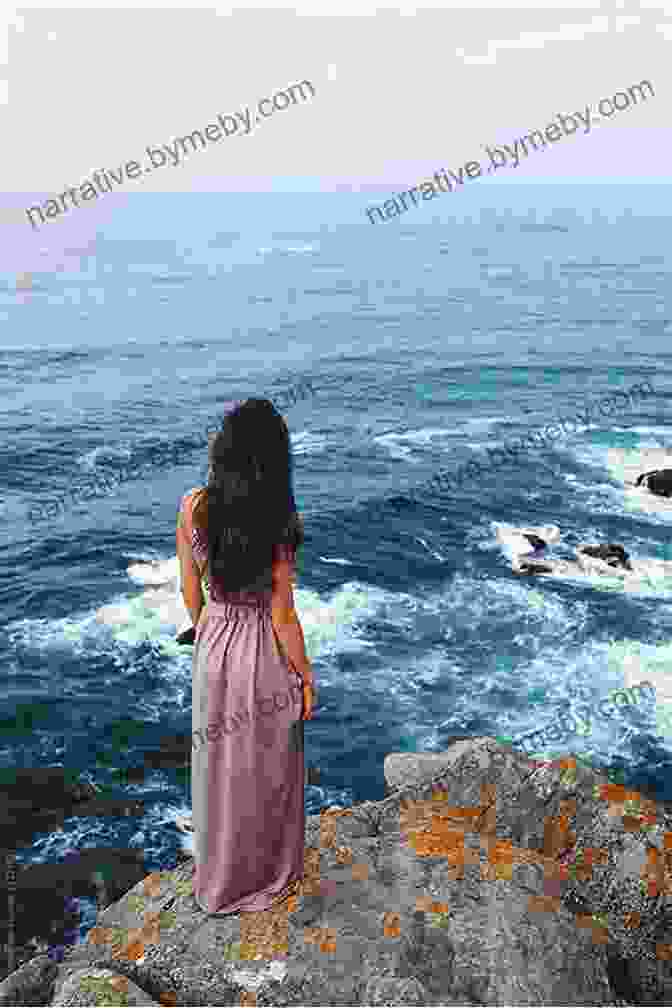 A Woman Standing On The Edge Of A Cliff, Looking Out At The Ocean. A Drop In The Ocean